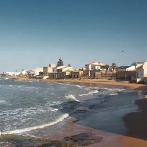 Beautiful coastal view of a sandy beach in Sicily, Italy under a clear blue sky.